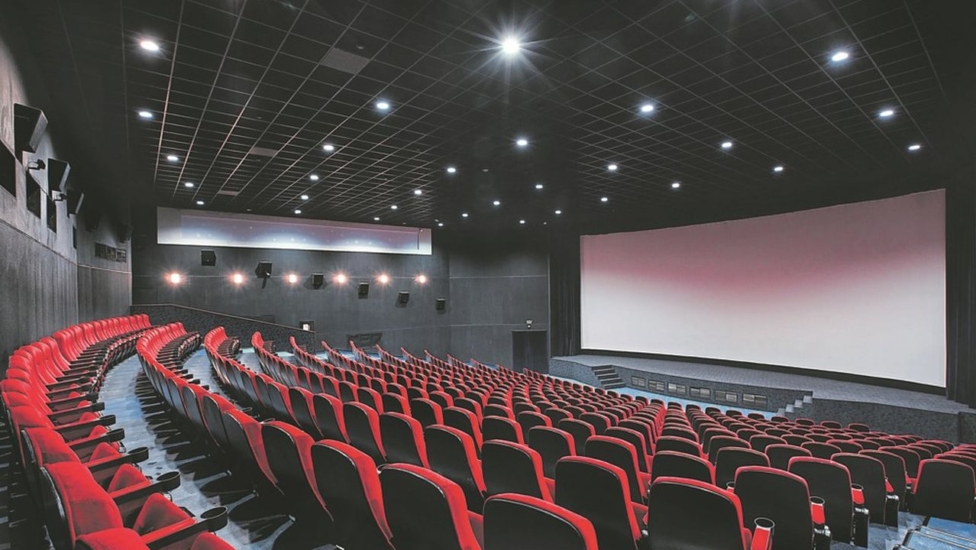 Russia, Nizhny Novgorod - may 29, 2014: October Cinema. Empty red cinema hall seats, comfortable and soft chairs. Perspective auditorium view.